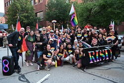 a group at the pride parade with a banner that says risd