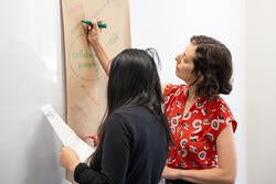 Teaching & Learning Lab workshop participants write thoughts on a large piece of paper