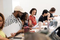 RISD faculty members review handouts at a Teaching & Learning Lab workshop