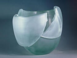 a blown glass piece in shades of teal