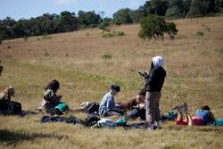 students sit outside and sketch in south africa