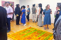 visitors check out paintings at exhibition opening in New York City