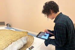 A student at work behind the scenes at the RISD Museum