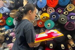 Emma Davis selects fabric as a Space NY intern