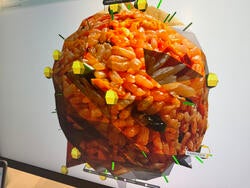 a digital rendering of a large spherical object made from many tiny, rice-like particles