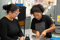 Ashley Harris demonstrates the proper technique for cutting sheet glass