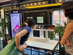 a student looks at a prototype
