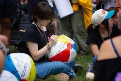 student writes on a beach ball