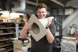 Josh Joseph holds up his ceramic traffic cone in the works