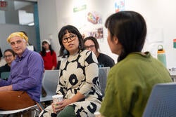 a class instructor listens to someone talking