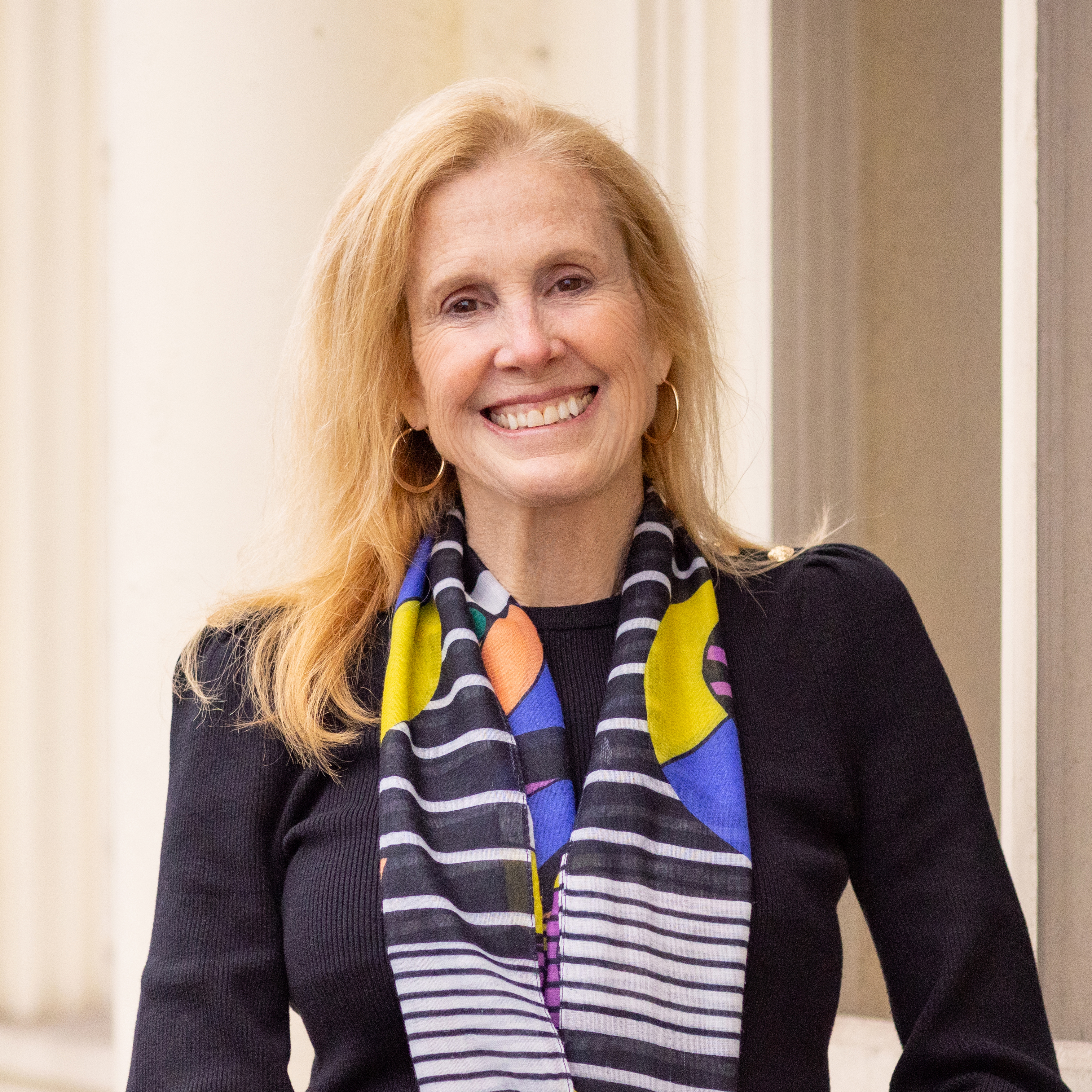 Amanda Clark MacMullen in a black top and colorful scarf