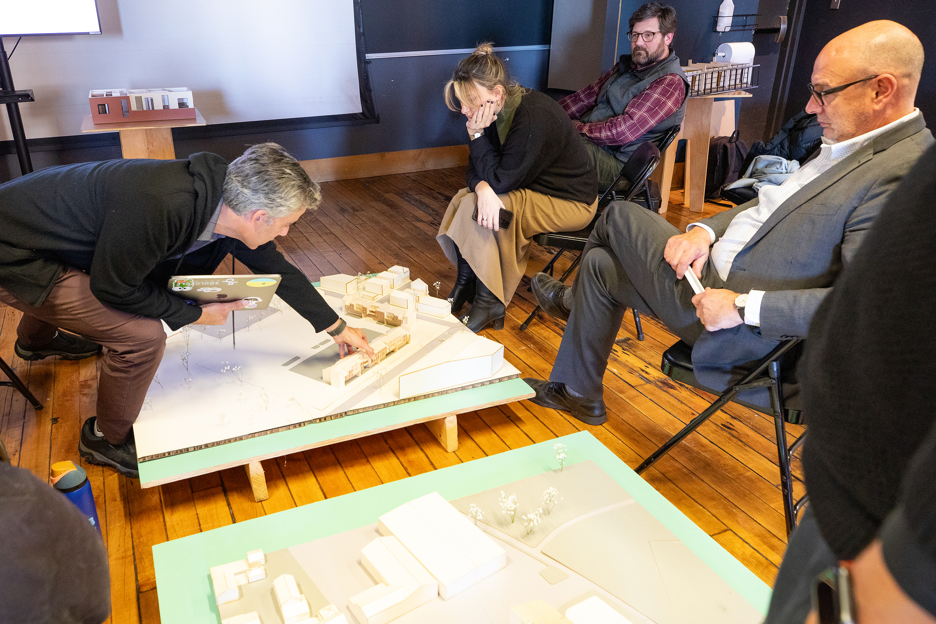 Architecture faculty member Manuel Cordero manipulates a student-built model at final crits