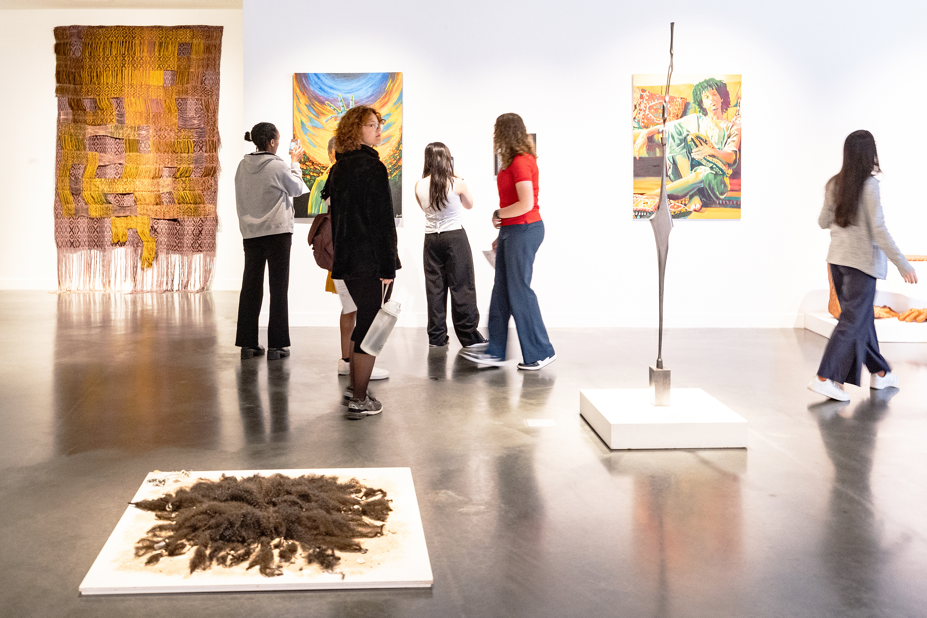 visitors to the Black Biennial explore the gallery