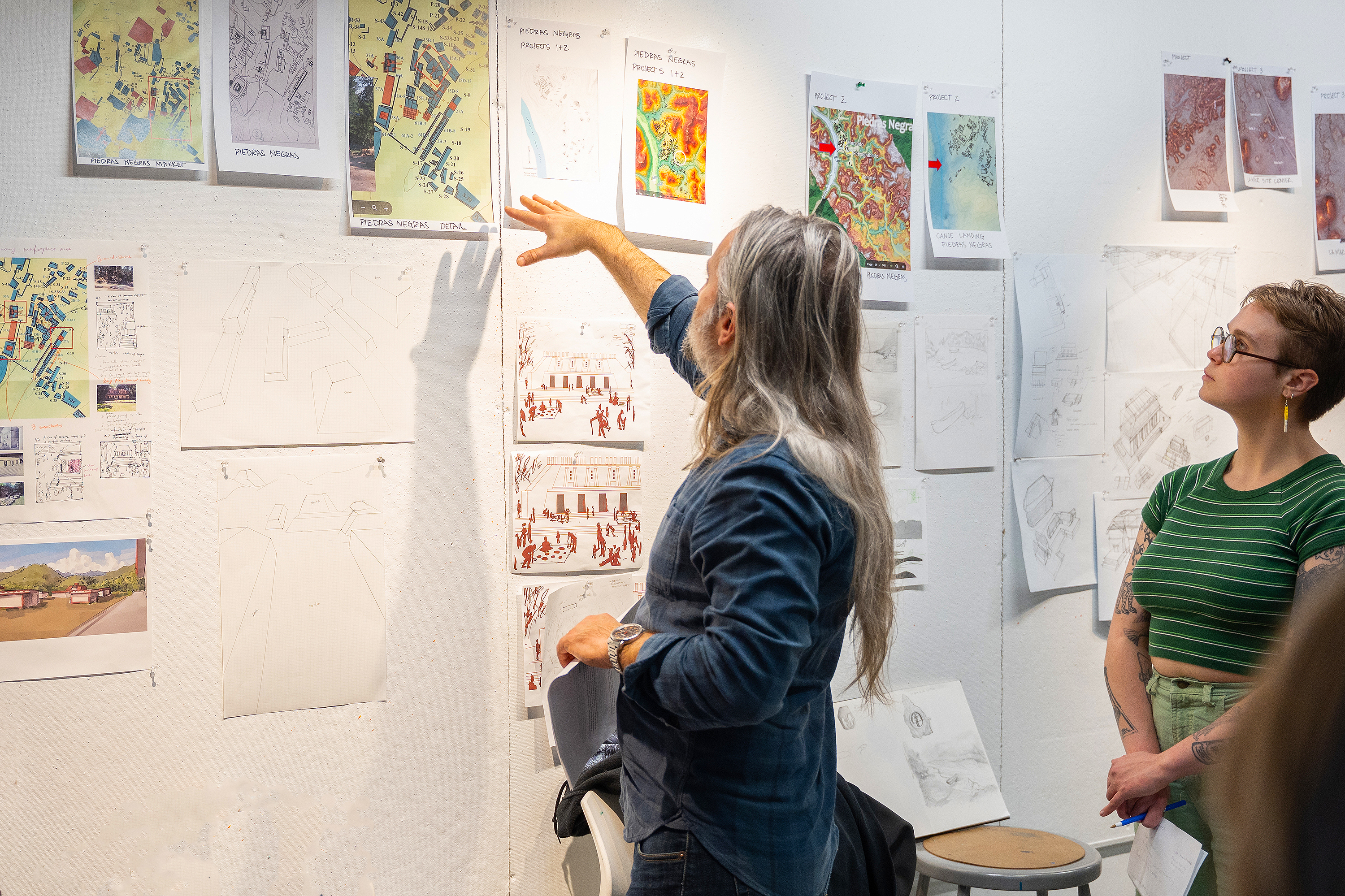 Scherer helps students interpret the site maps that will inform their illustrations