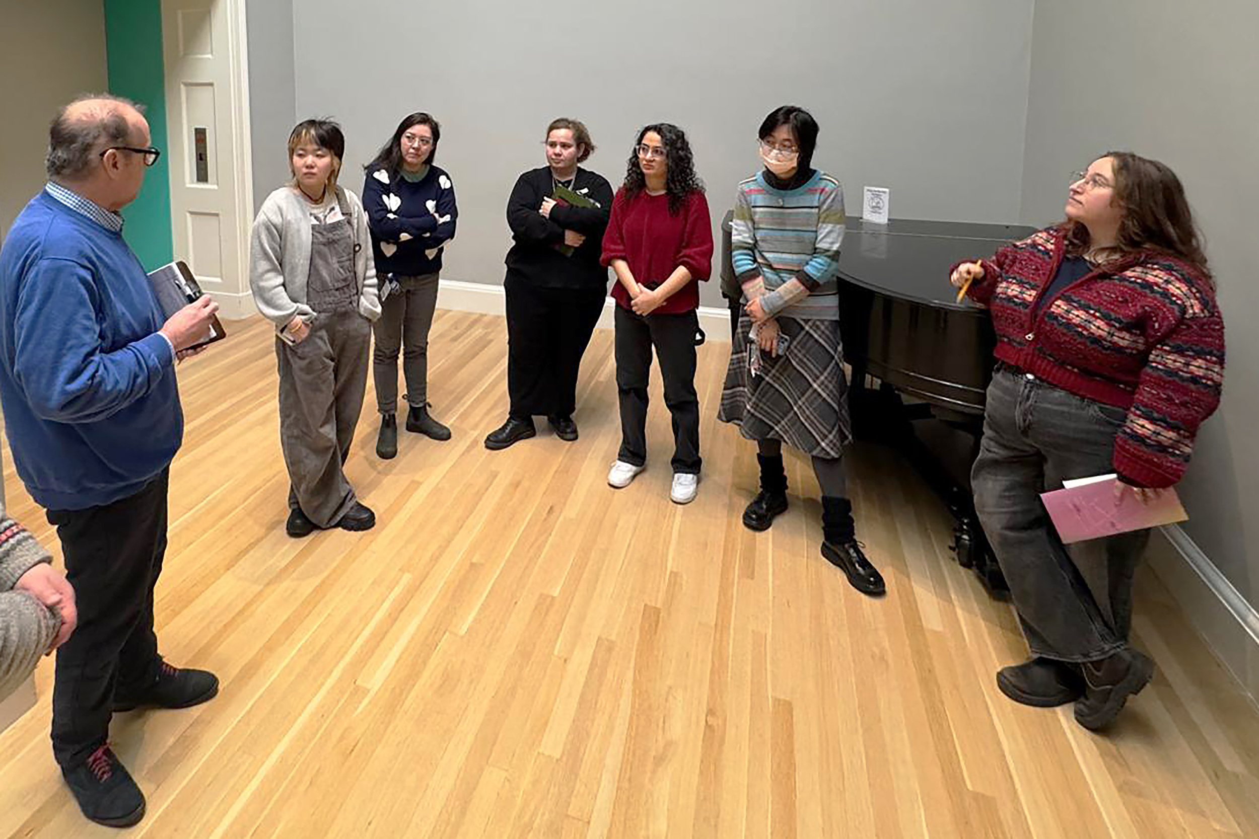 the class meets with museum staff in the skylight gallery