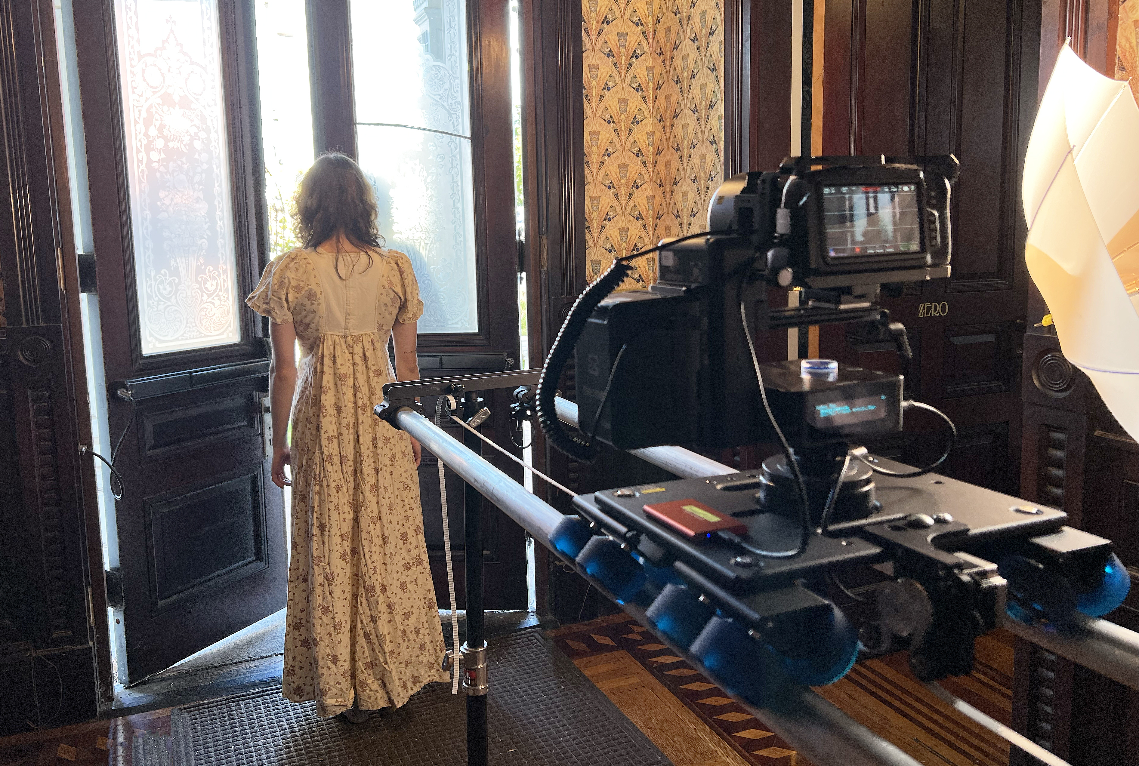 a student in an old-fashioned dress is filmed using an eMotimo setup