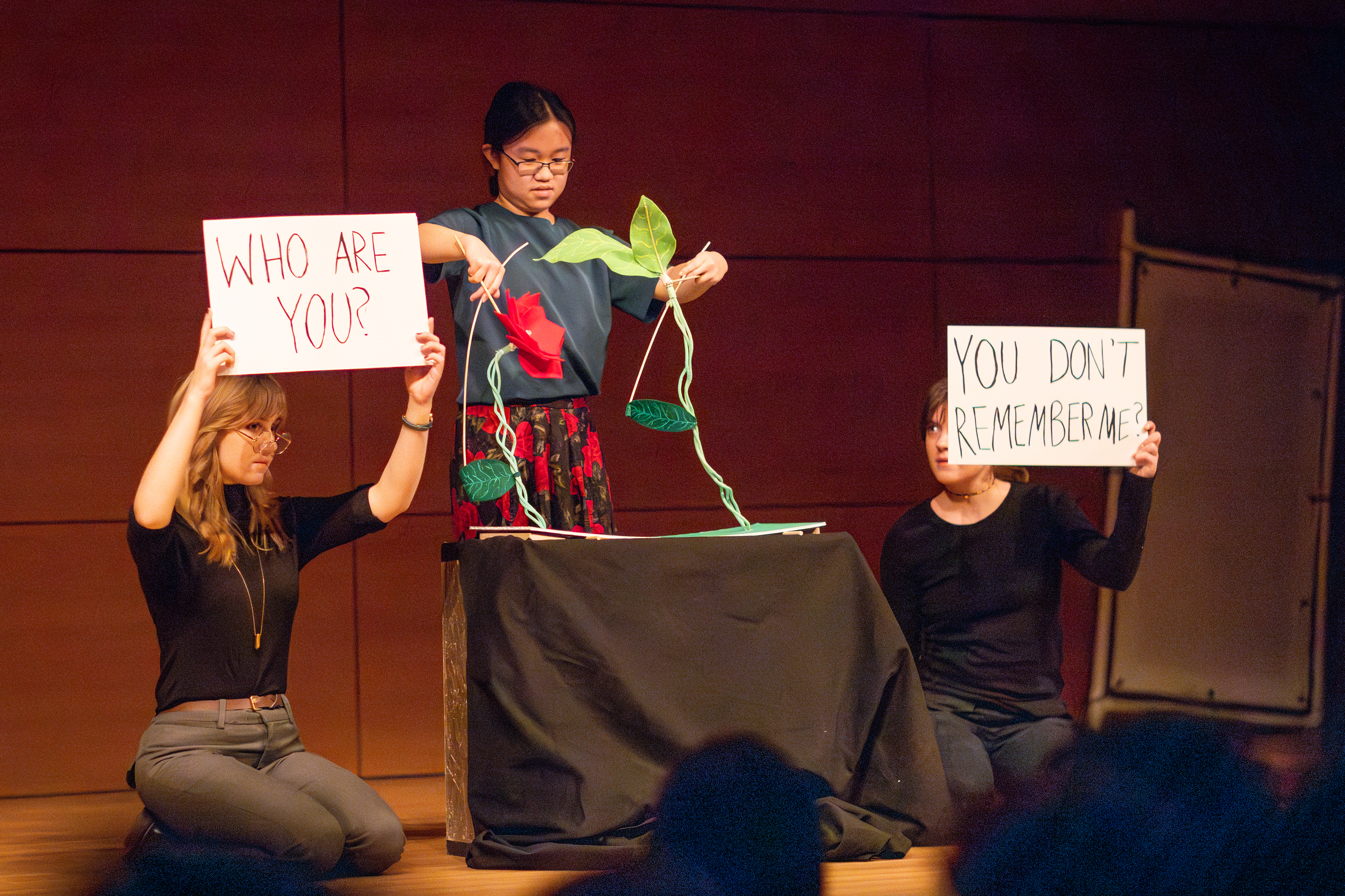 three students perform a piece about aging