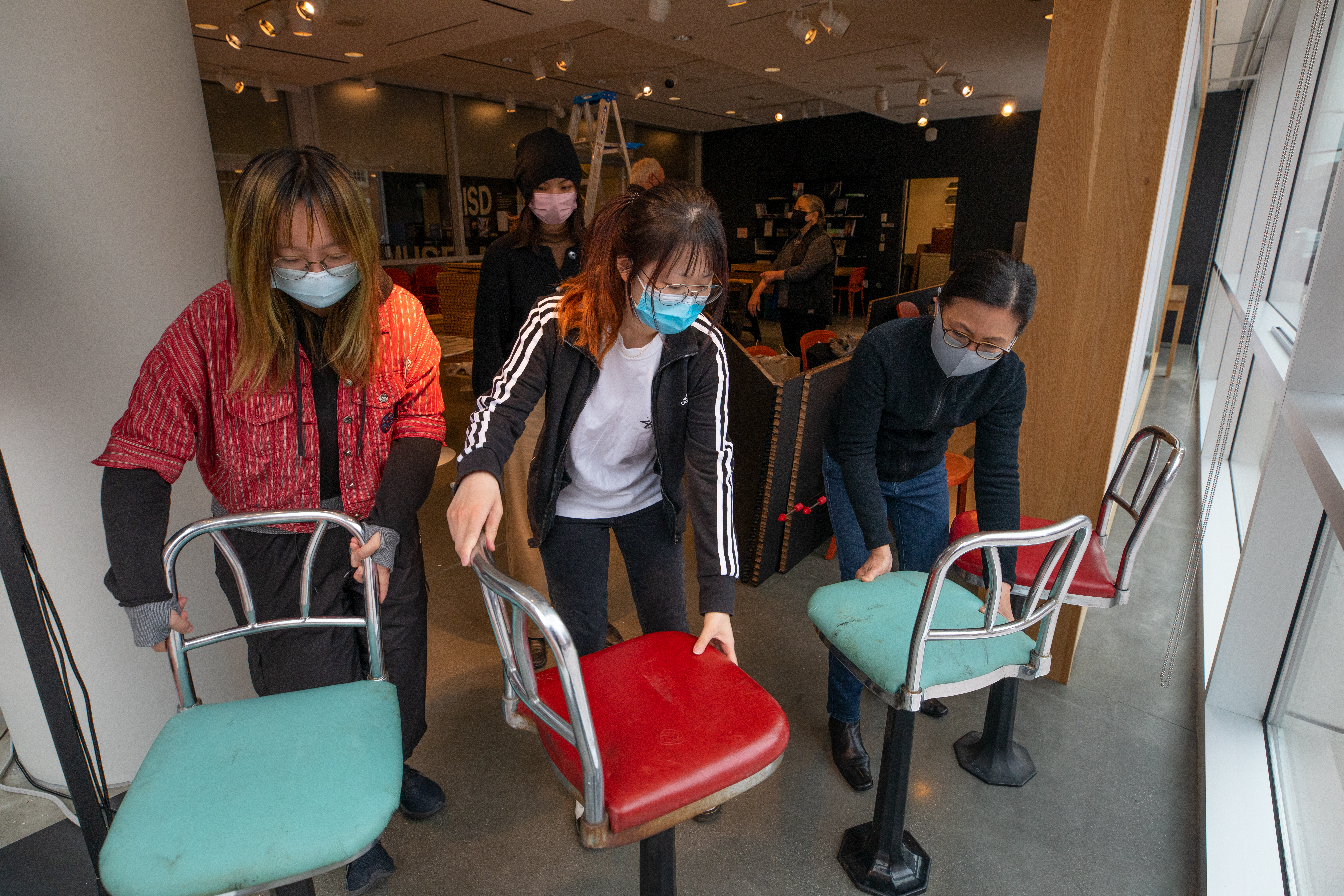 students installing exhibition 