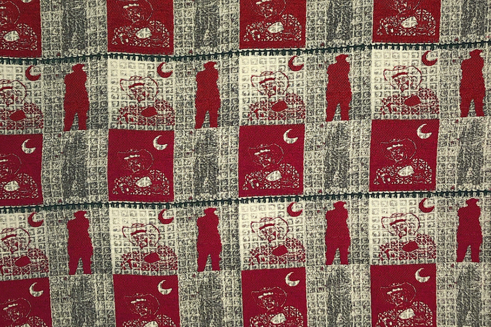 red and white textile featuring abstract images of a cowboy