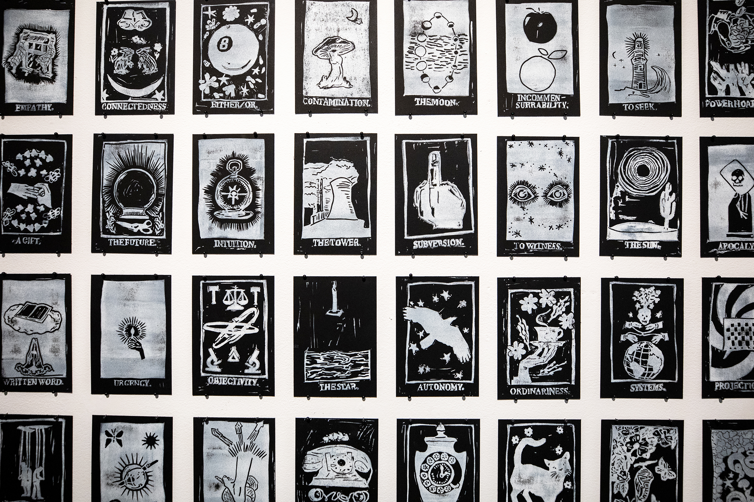 a wall of black-and-white prints