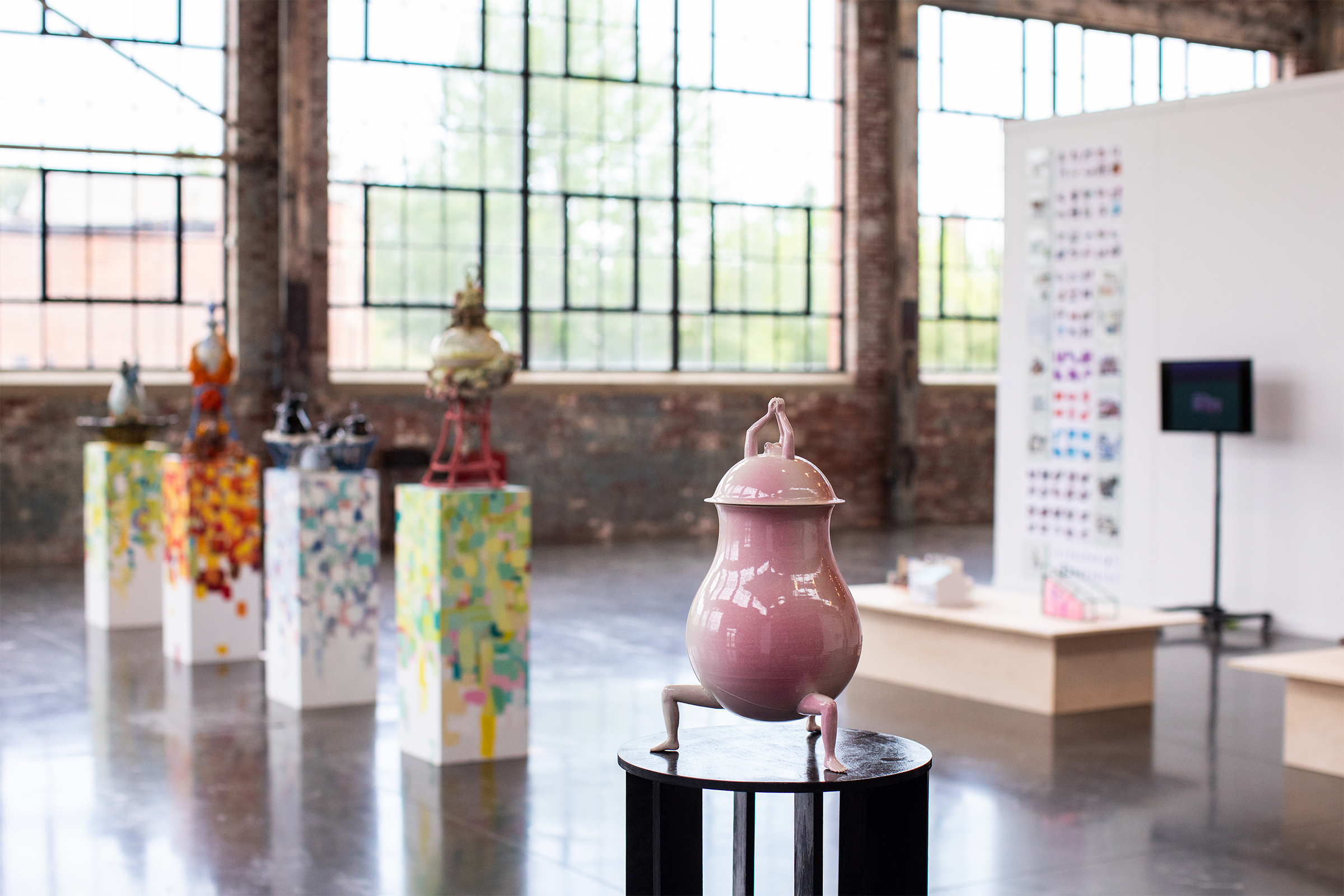 quirky, colorful ceramic vases with lids on display in gallery