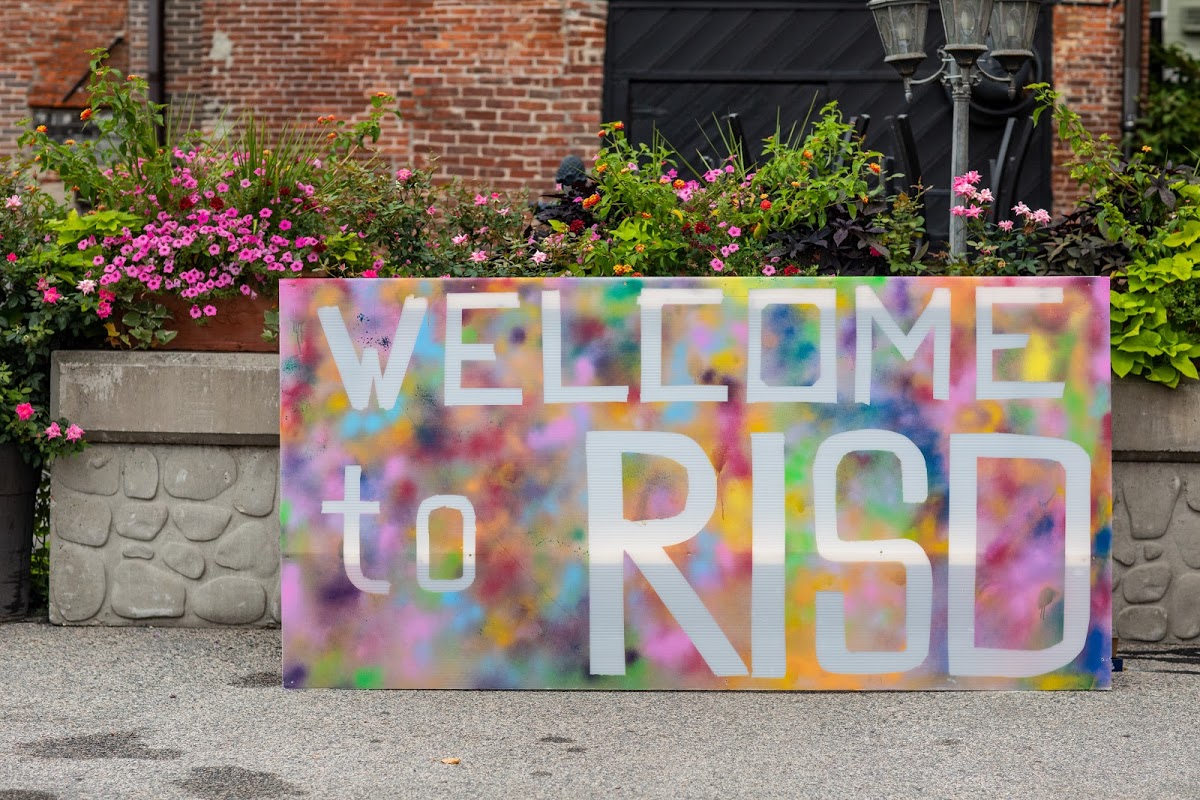 Large, brightly colored hand-made "welcome to RISD" sign