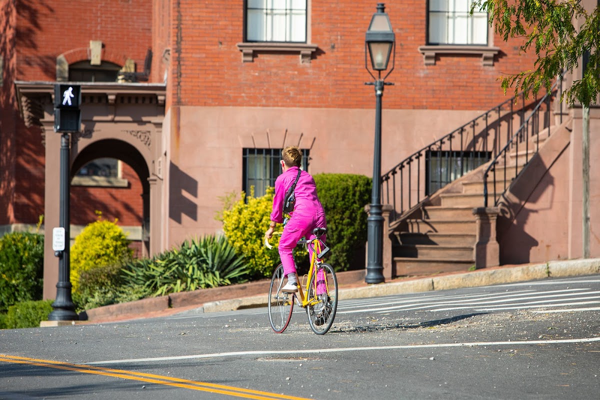 Person rides bicycle down Benefit Street