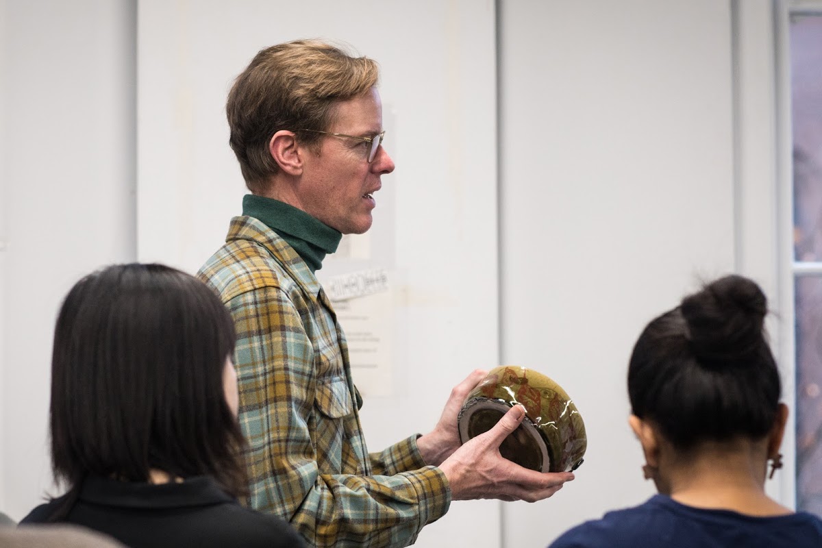 Printmaking Professor Andrew Raftery offers feedback during crit.