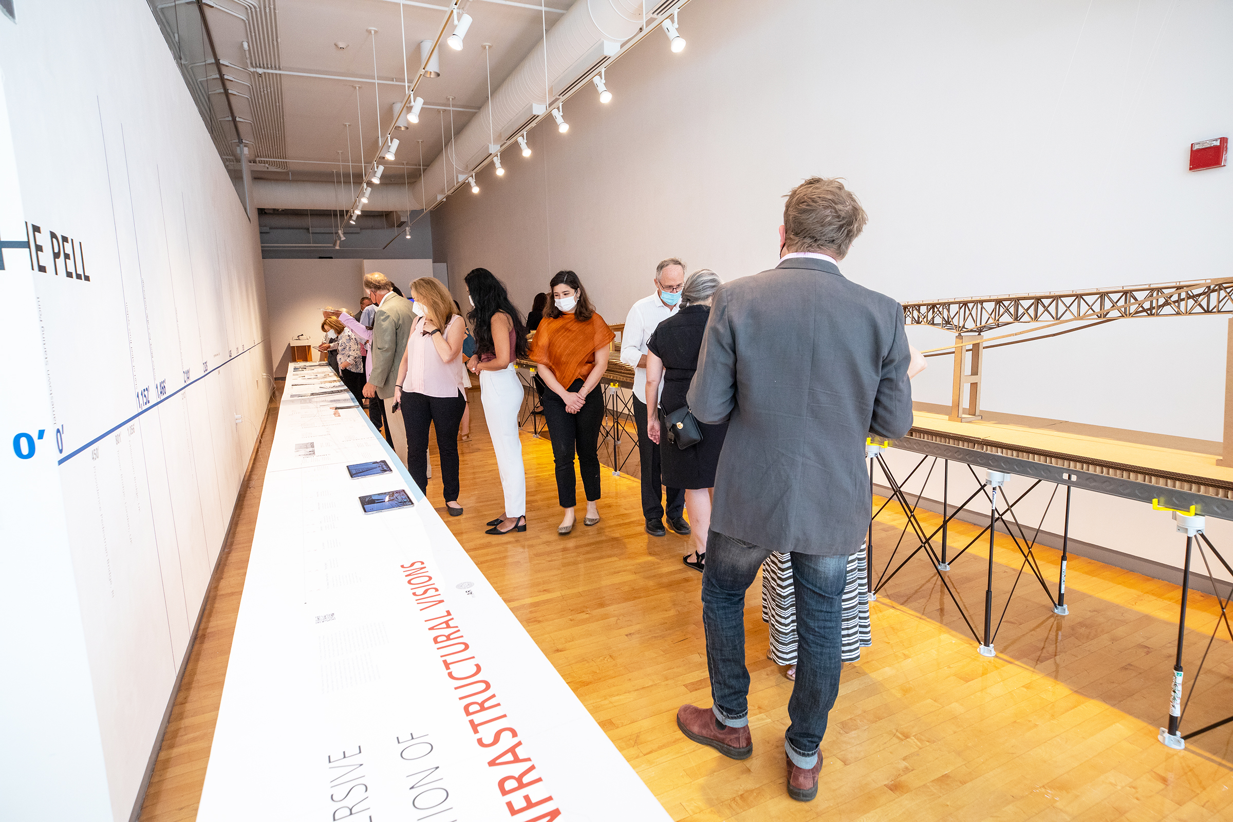 visitors examine the timeline at Crossing the Pell exhibition