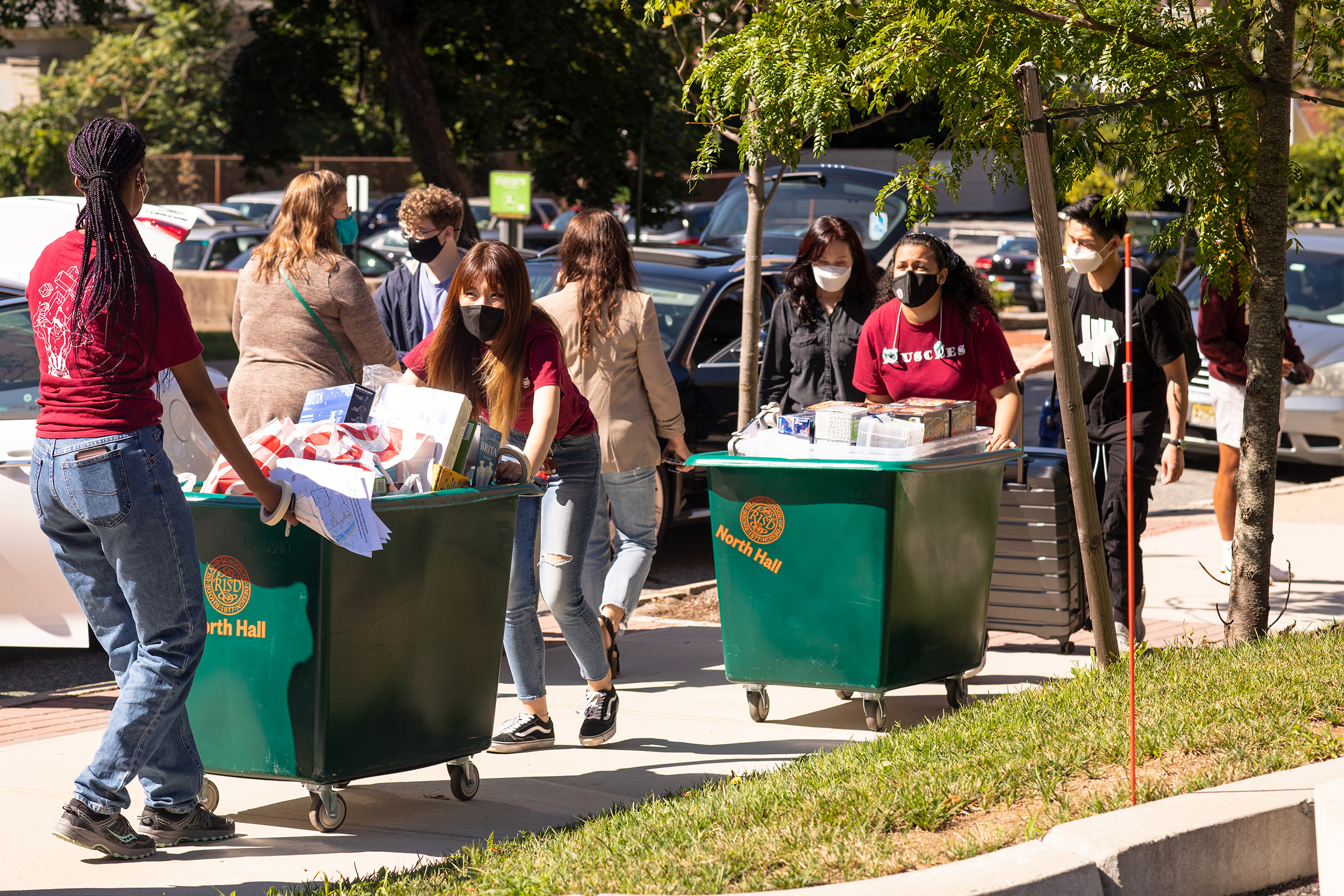 students roll carts of their belonging up College Hill