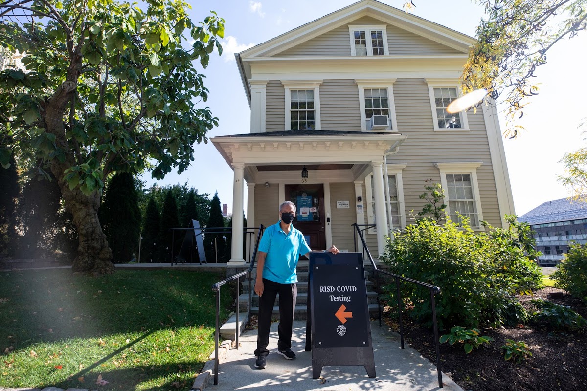 Executive Director of Integrated Health and Wellness Bob Samuels standing with covid testing sign outside of Thompson House