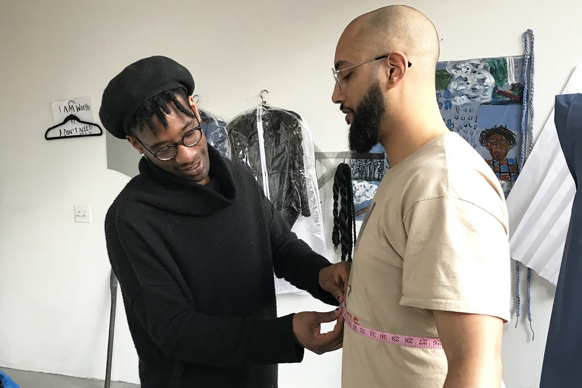 Grad student Jarret Key MFA 20 PT measures Smith for performance piece clothing
