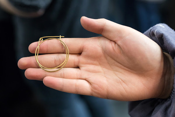 Hand holding a piece of jewelry