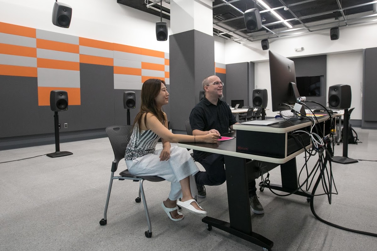 Ji Hoo Kim MFA 20 DM and EFS Programs Head Shawn Greenlee 96 PR working in the new spatial audio studio