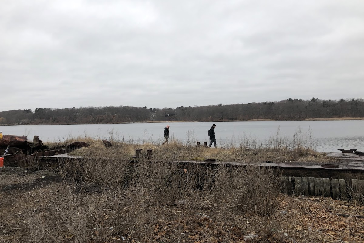 People walking along abandoned dock area of Phillipsdale Historic Village, East Providence, RI