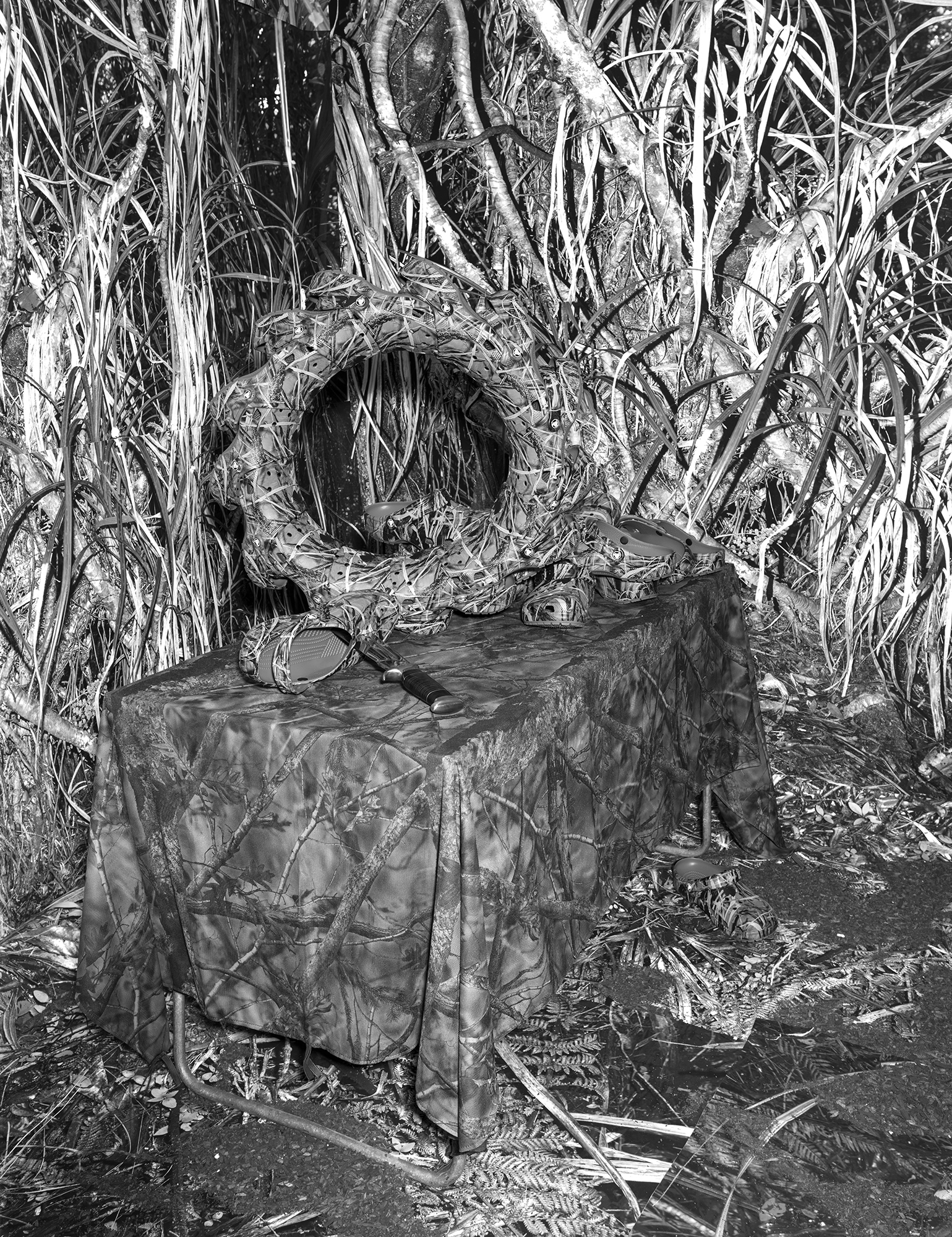black-and-white image of camouflage gear used by hunters