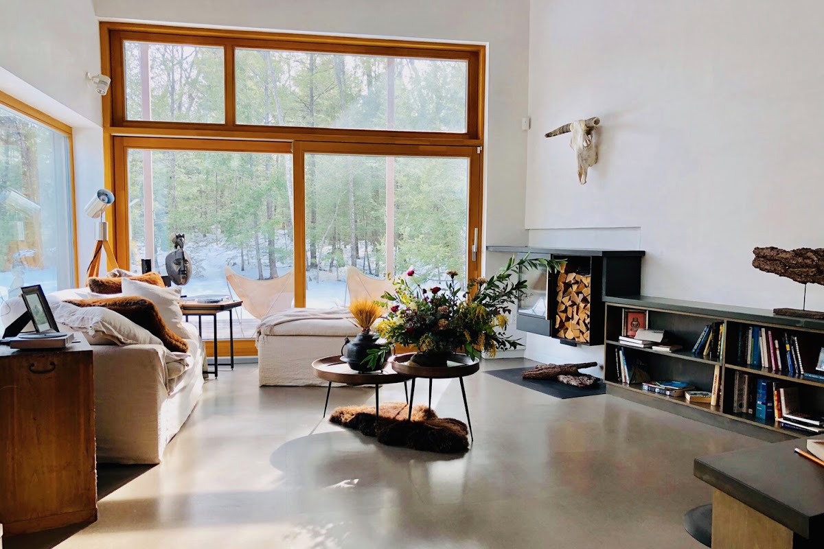 Living room with large windows in an energy-efficient home by Laura Briggs BArch 82, Jonathan Knowles BArch 84, and Jonsara Ruth 92 ID.