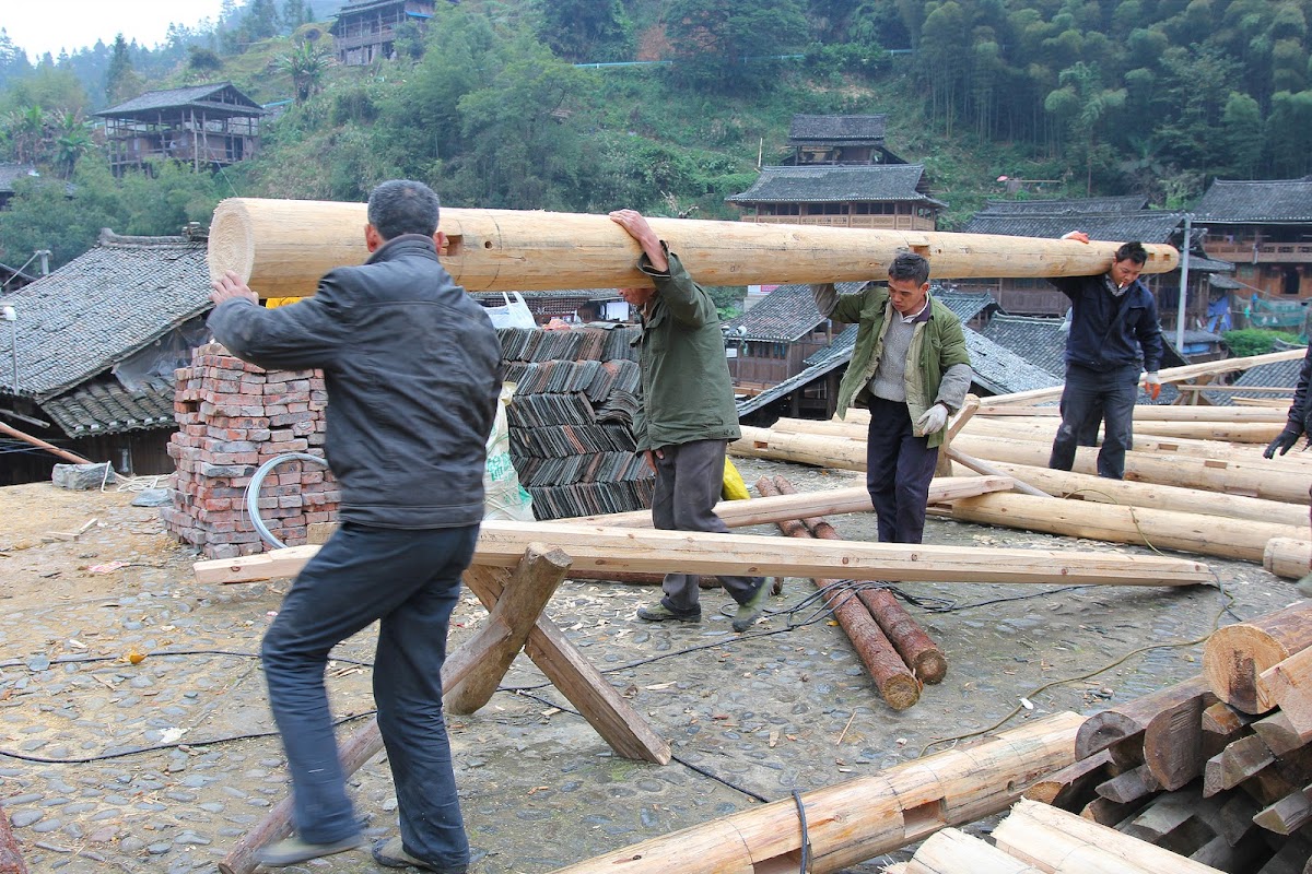 Villagers carry lumber together in China