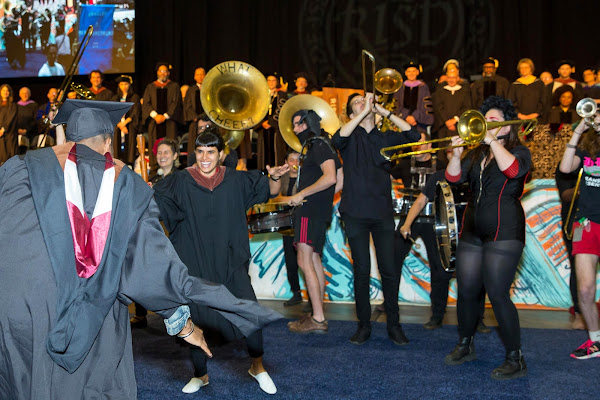 Graduates dancing with What Cheer band at commencement