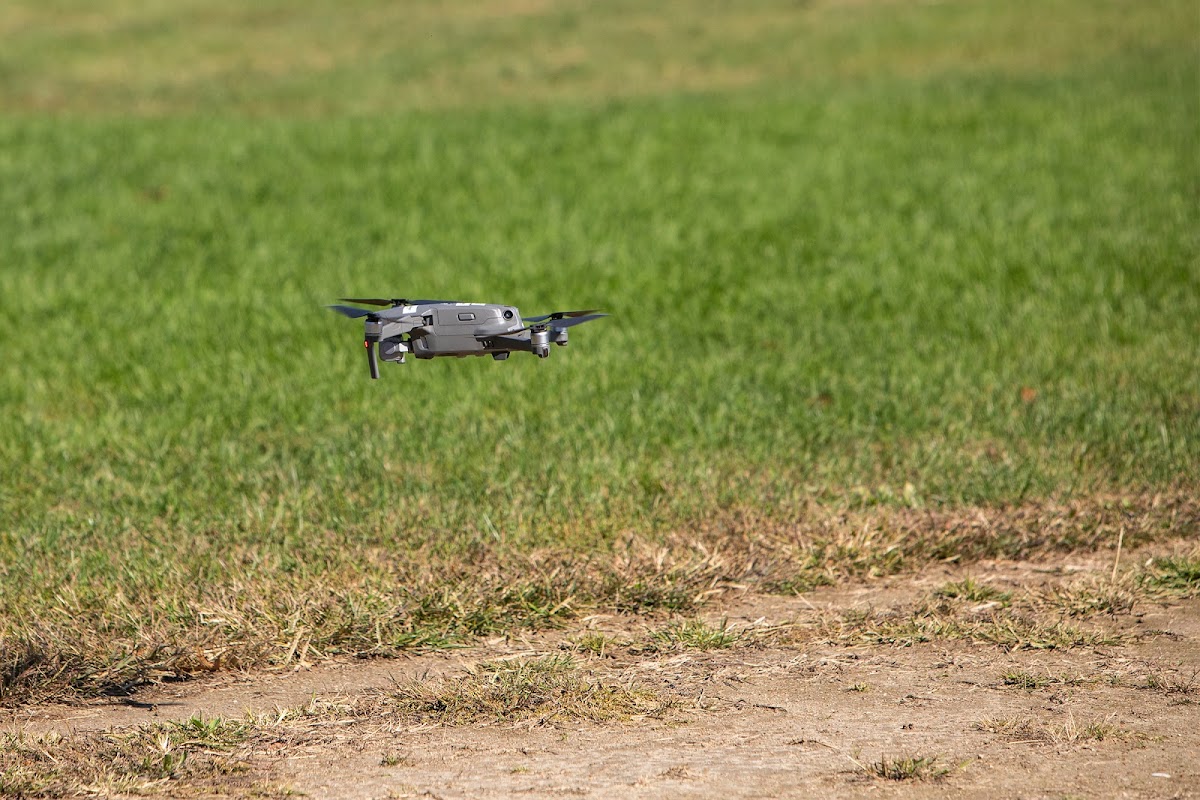 Drone flying above grass