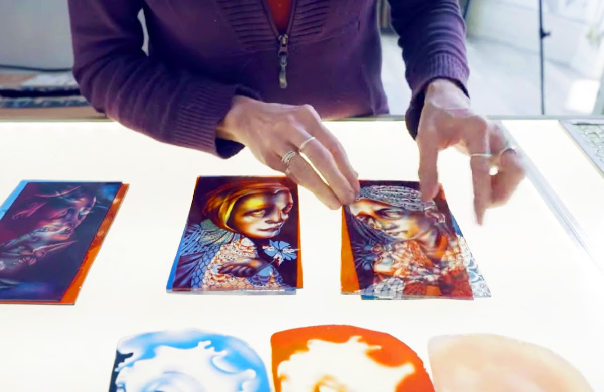 Hands placing images on a light table