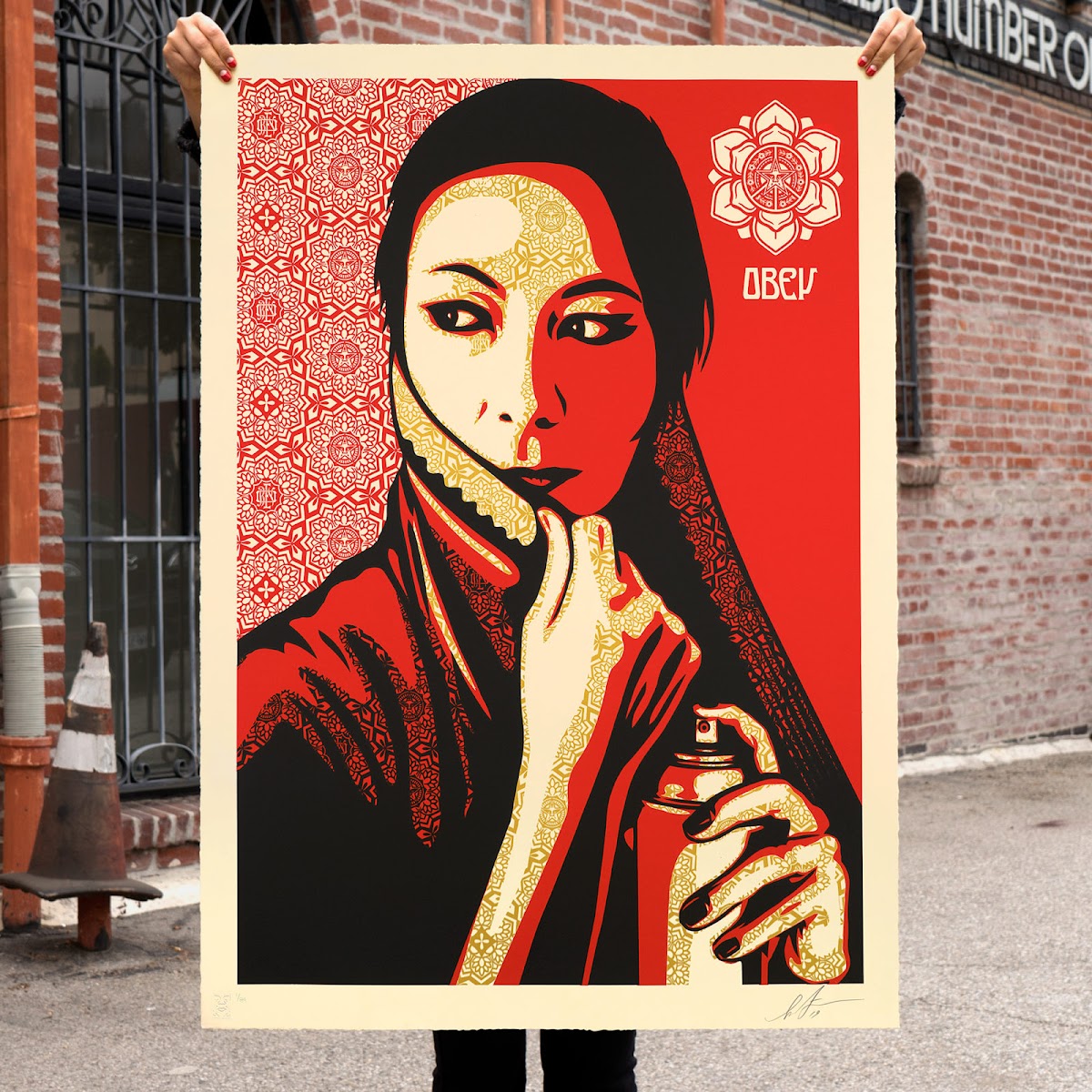 Shepard Fairey 92 IL poster of a muslim woman holding a spray can