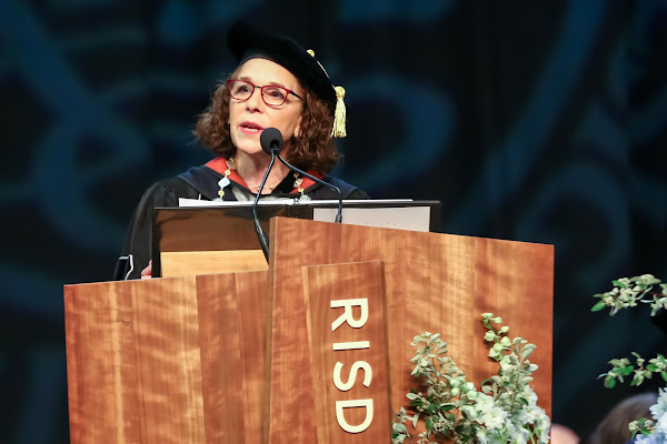 President Rosanne Somerson speaking on stage at podium at commencement