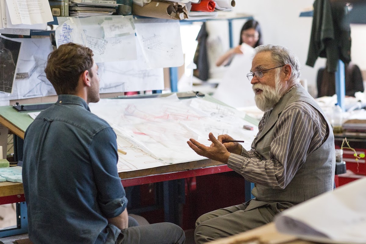 Professor talking to a student in a studio