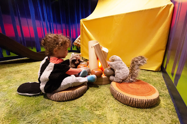 Toddler playing with toy animals in exhibit by Margaret Middleton 08 ID