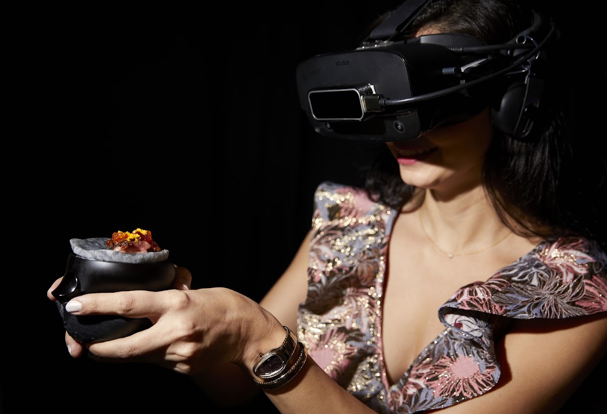 Woman wearing VR goggles, RISD faculty member Mattia Casalegno