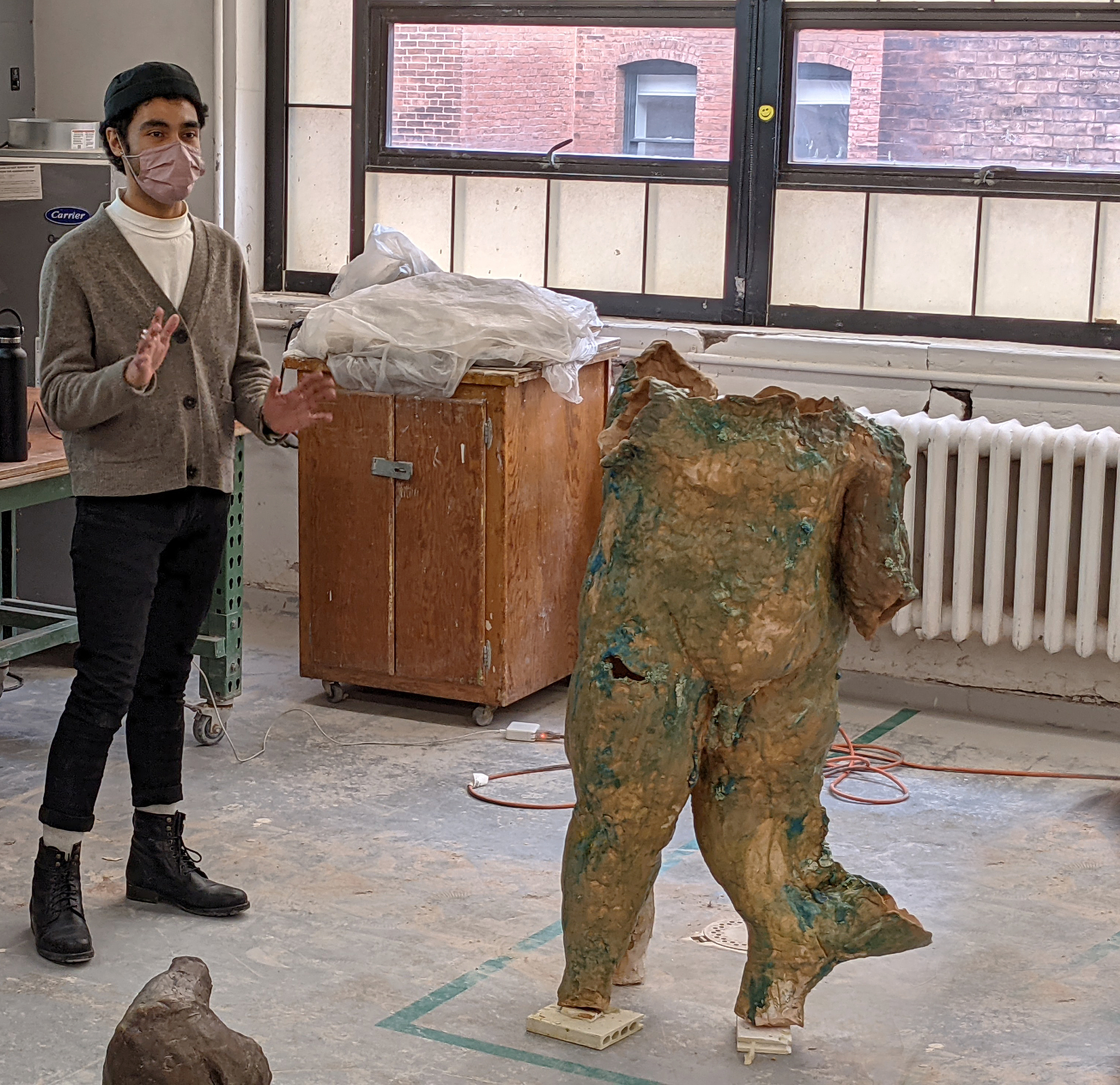 a Ceramics student presents a figurative piece