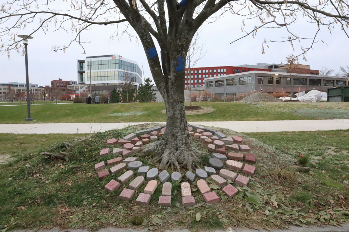 The Bejewelled City installation at the foot of a tree