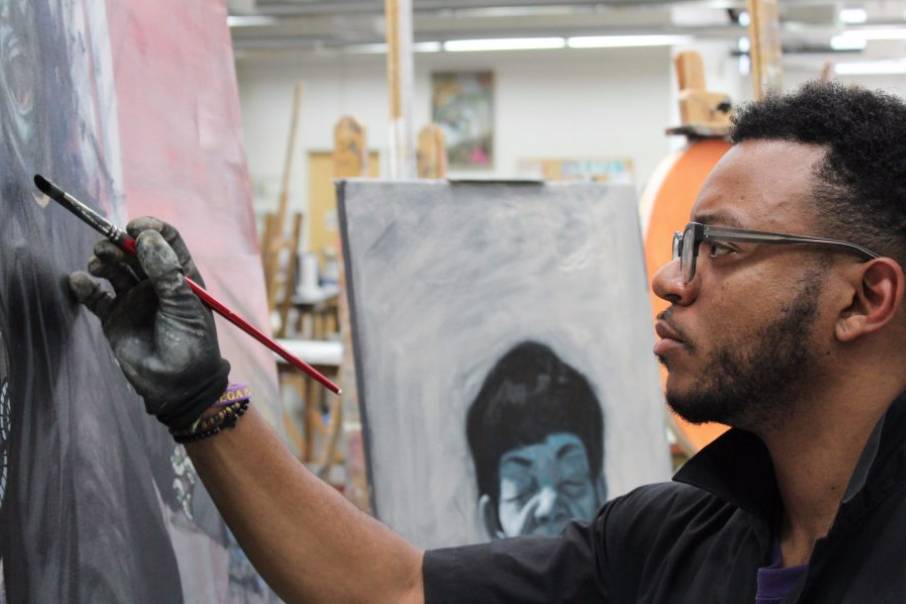 EFS Assistant Professor Spencer Evans painting in the studio