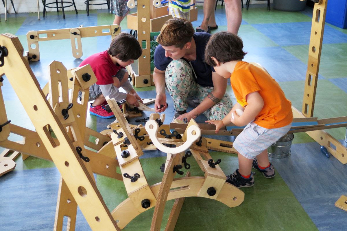  Associate Professor Cas Holman playing with wooden building toy with children